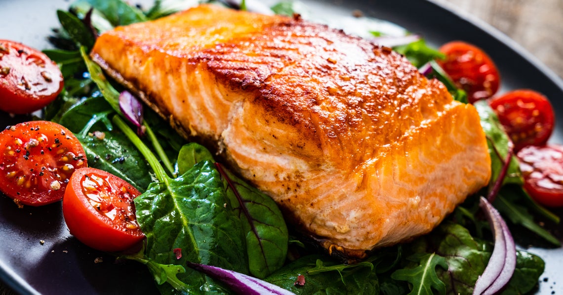baked salmon over a bed of sautéed spinach