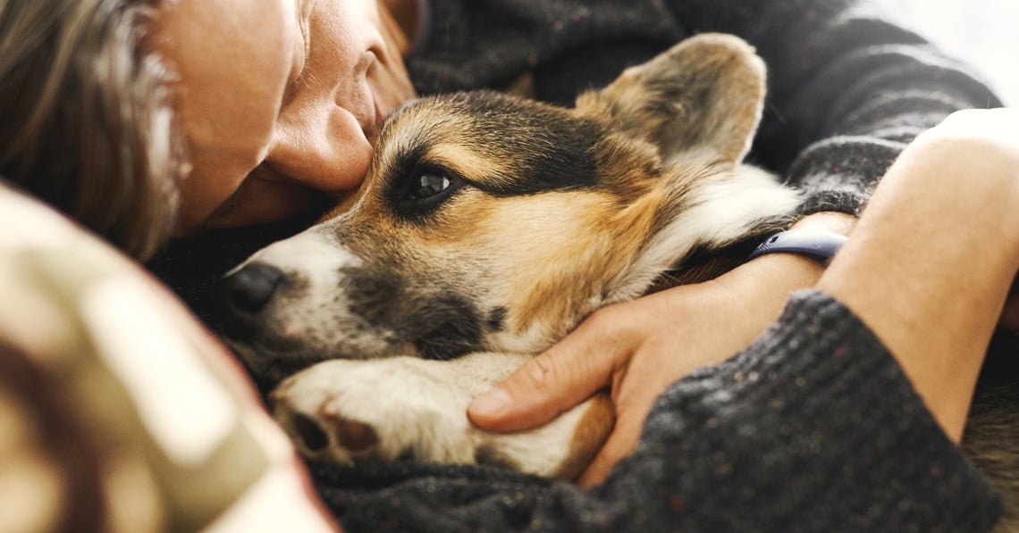 young man snuggling with his dog