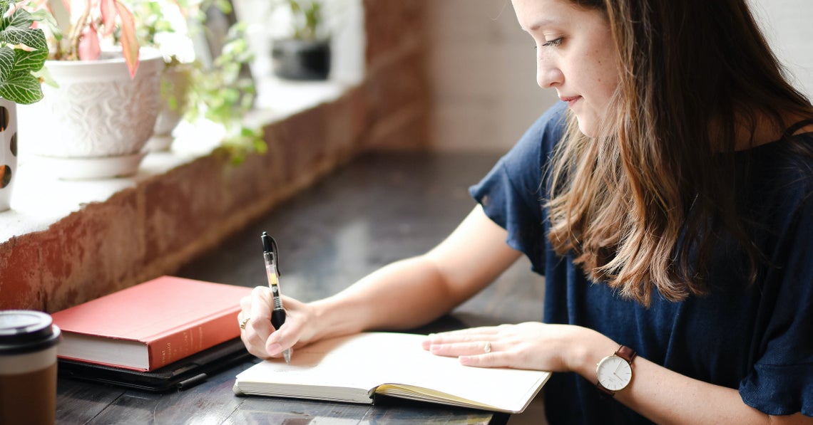 woman writing on her journal