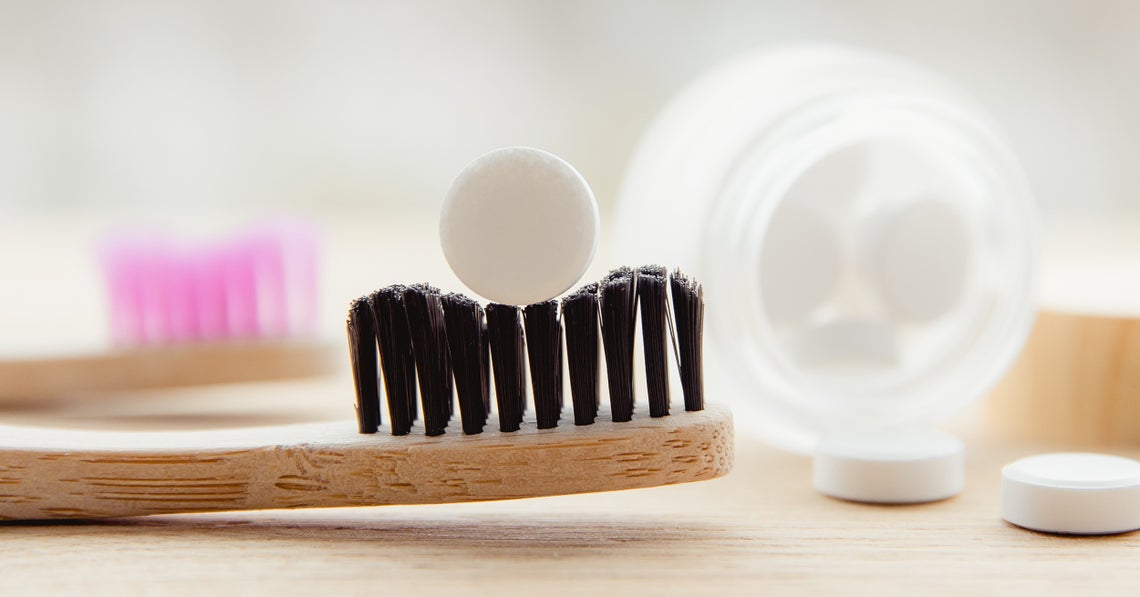 toothbrush with toothpaste tablet on it