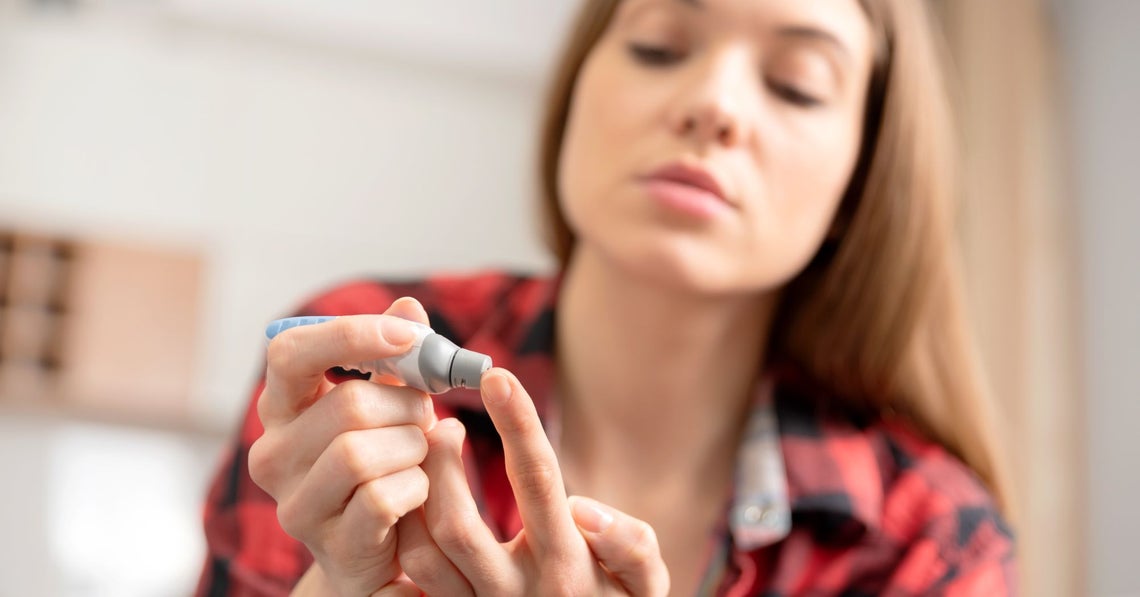 young woman checking her blood sugar level