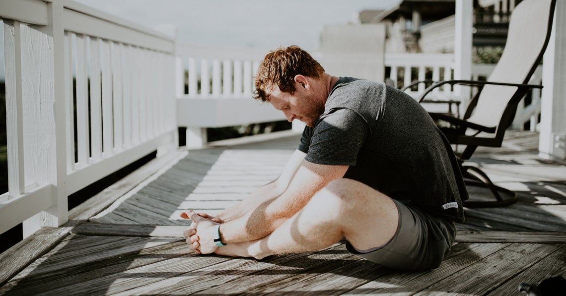 man stretching at his patio