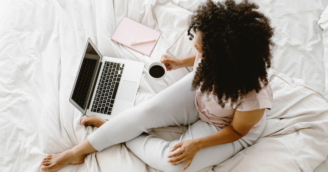 woman enjoy a cup of coffee while working at home