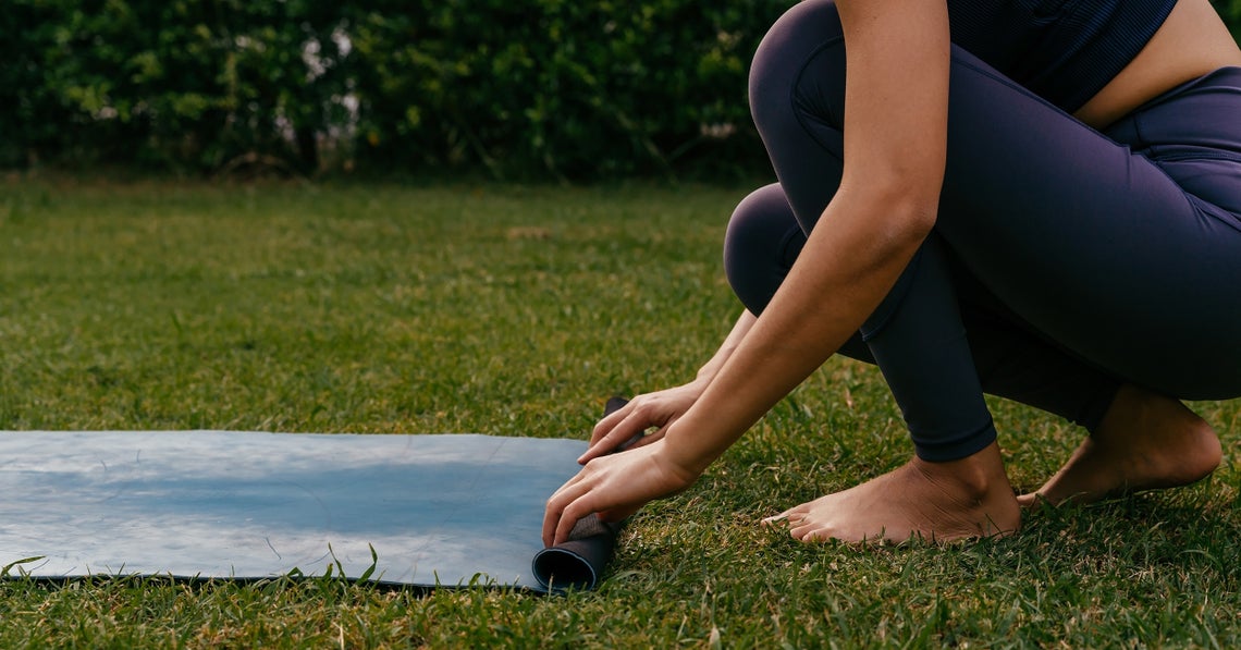 woman doing yoga on grass