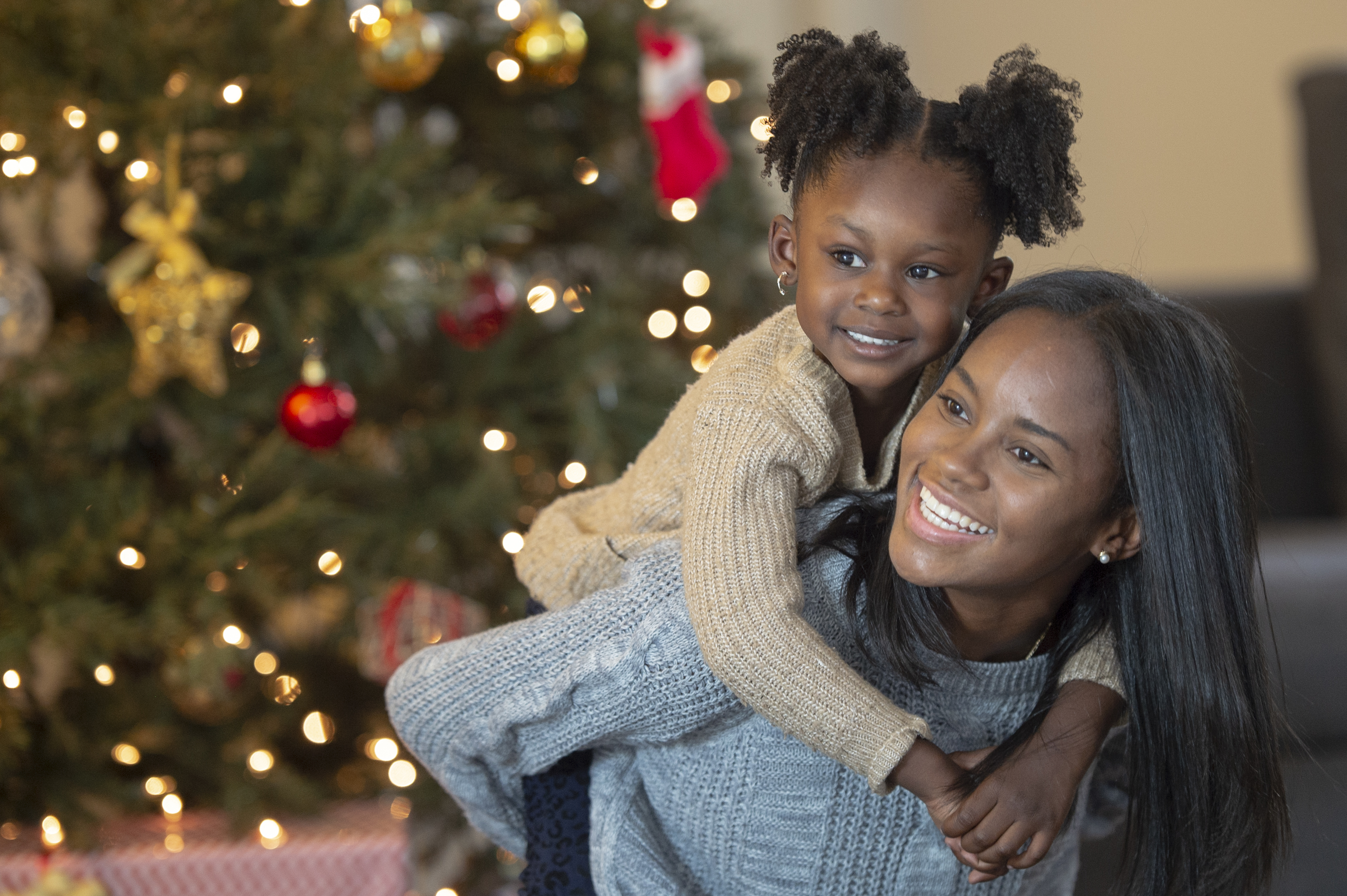 Mother and daughter by tree