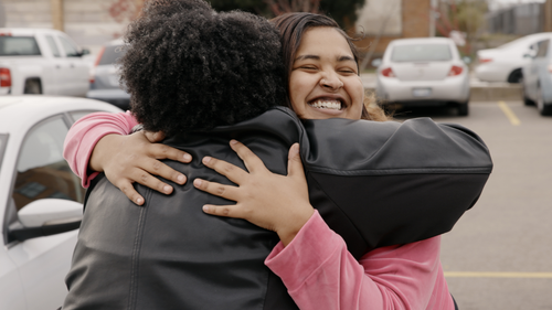 Two people hugging.