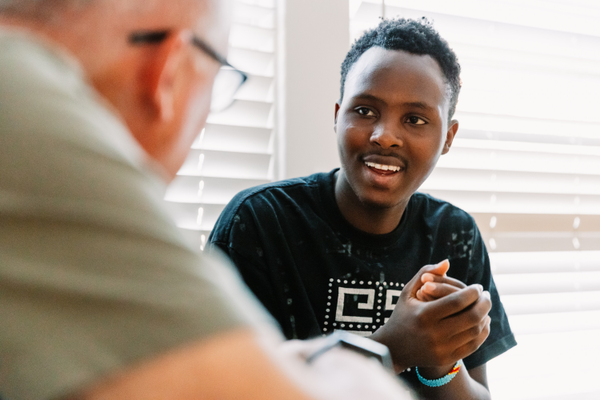 Teen talking to older adult
