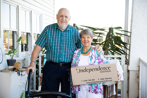 Happy couple displaying their Independence Australia order delivery box 