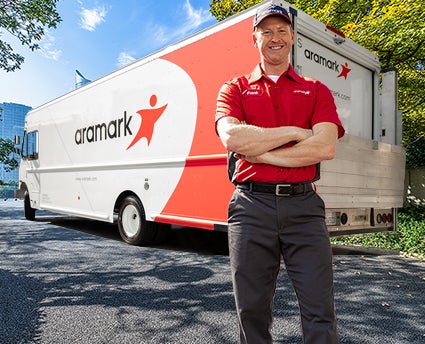 Aramark representative standing in front of a delivery truck