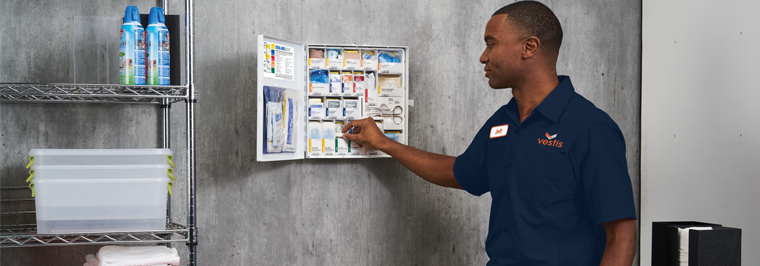 Vestis service representative monitoring a customer's workplace first aid kit