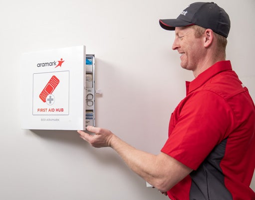 Aramark service representative monitoring a customer's first aid kit for business