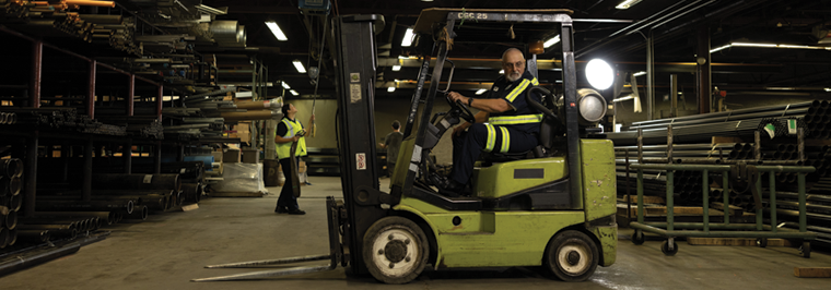 Two manufacturing employees wearing safety workwear, including hi visibility uniforms