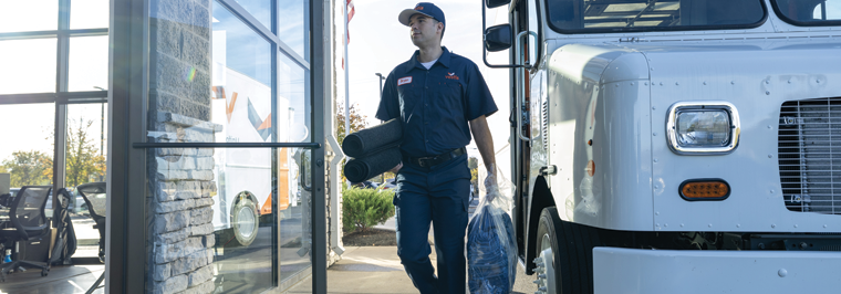 Vestis service representative delivering workplace supplies for rent