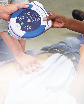 Employees responding to a workplace accident using an AED HeartSine® samaritan® PAD 450P