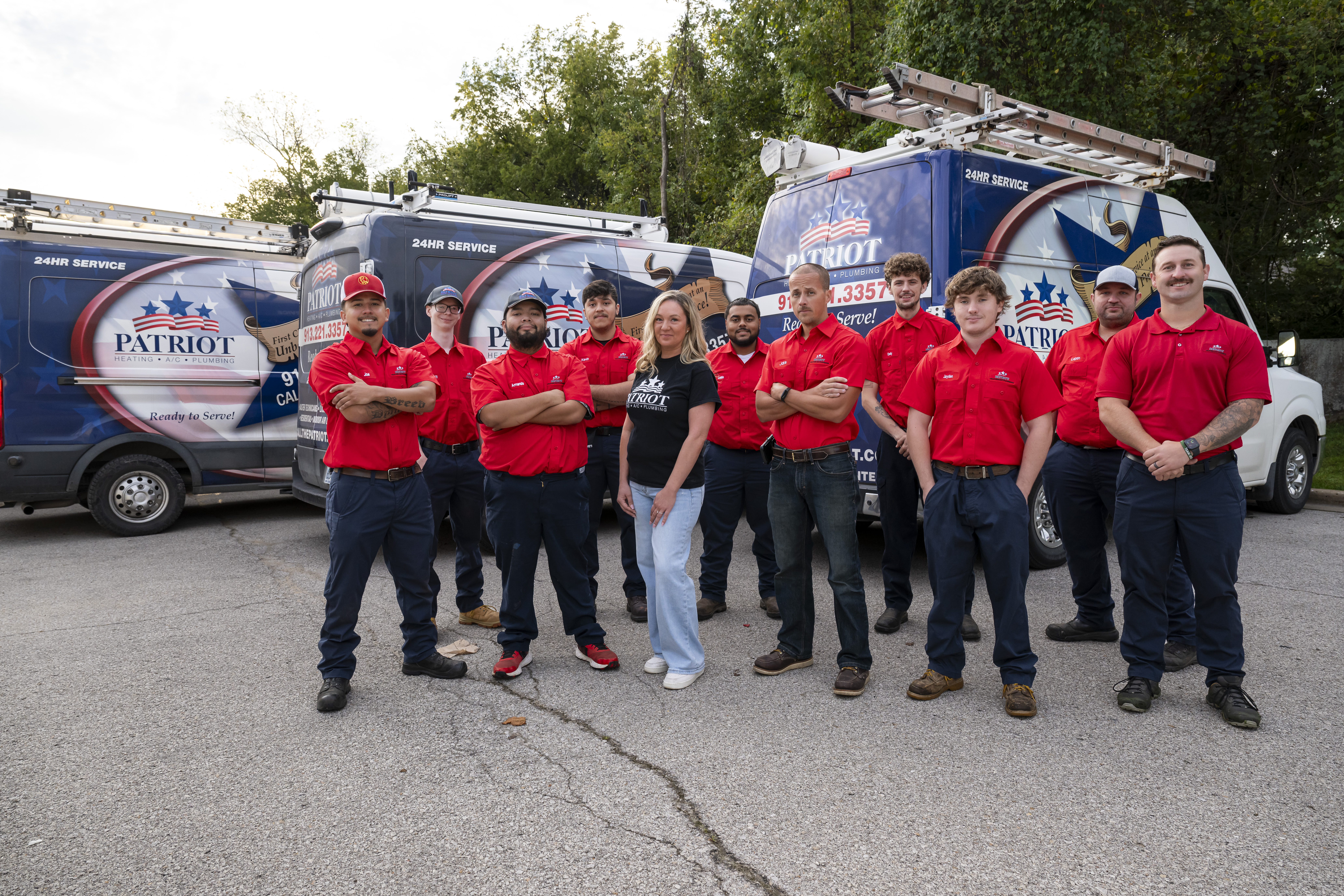 The Patriot Heating & AC team standing in front of their service vans