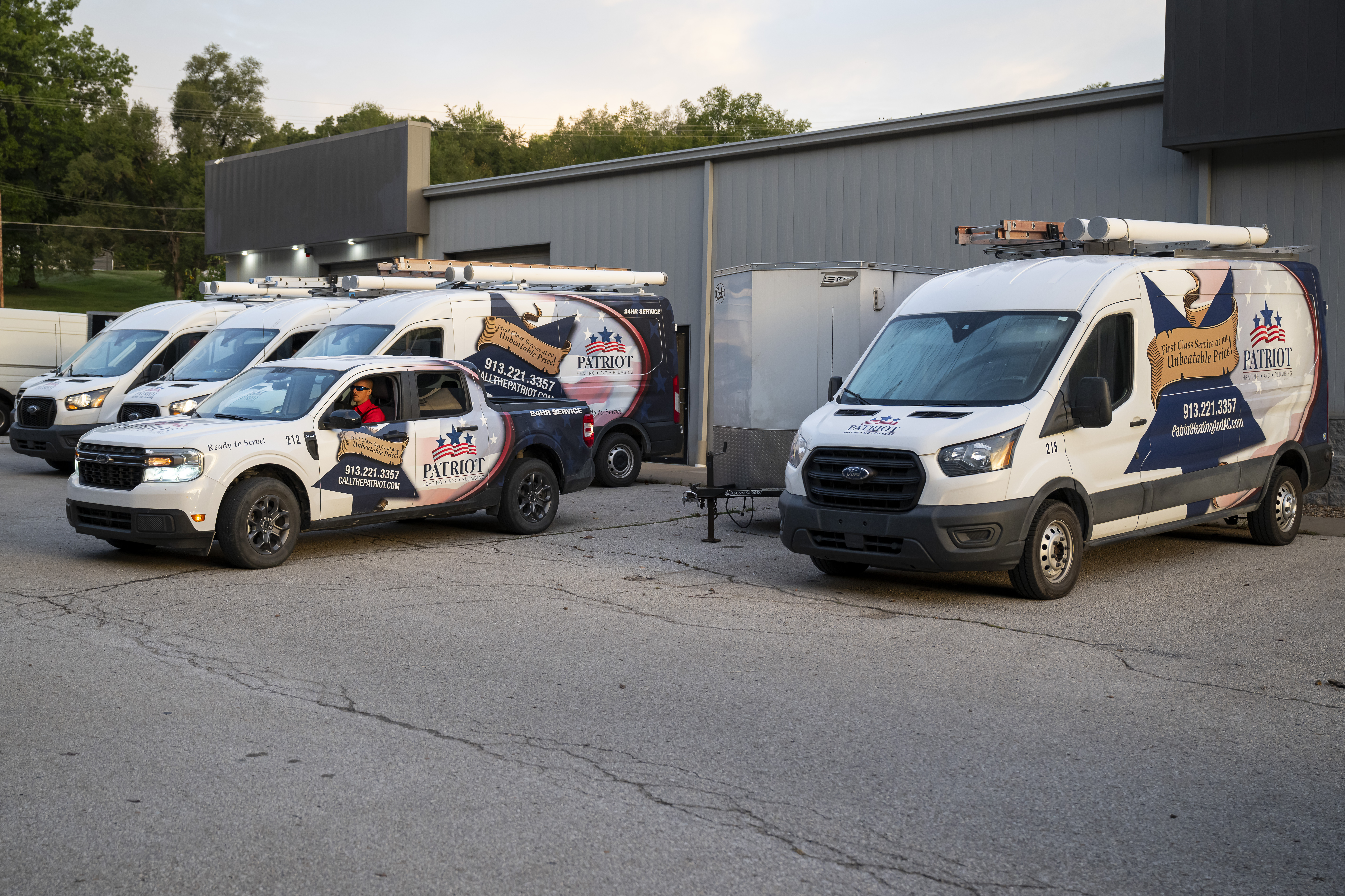 Patriot Heating & AC service vans and trucks lined up at the shop