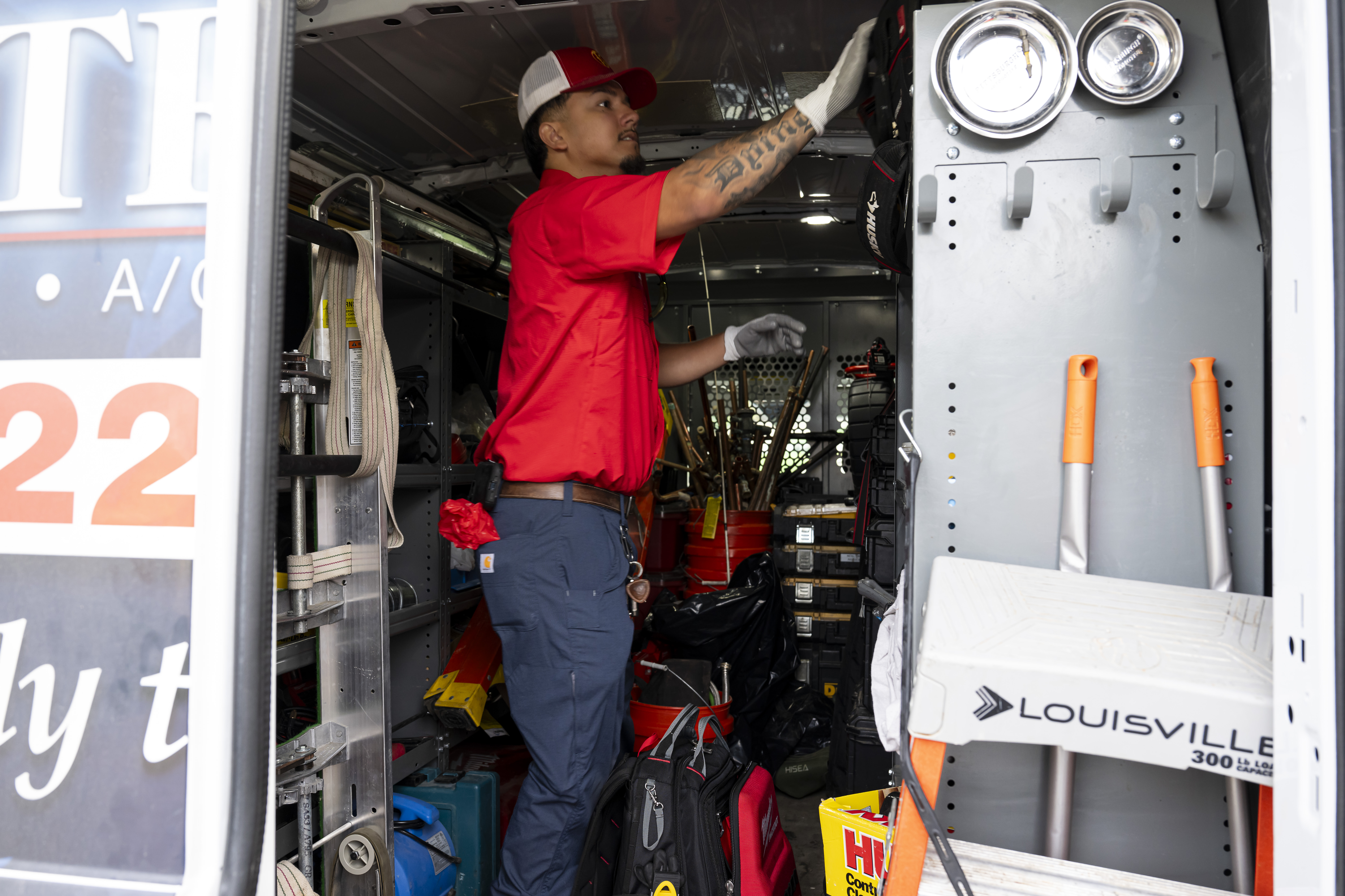 Patriot Heating & AC technician inside a stocked service van