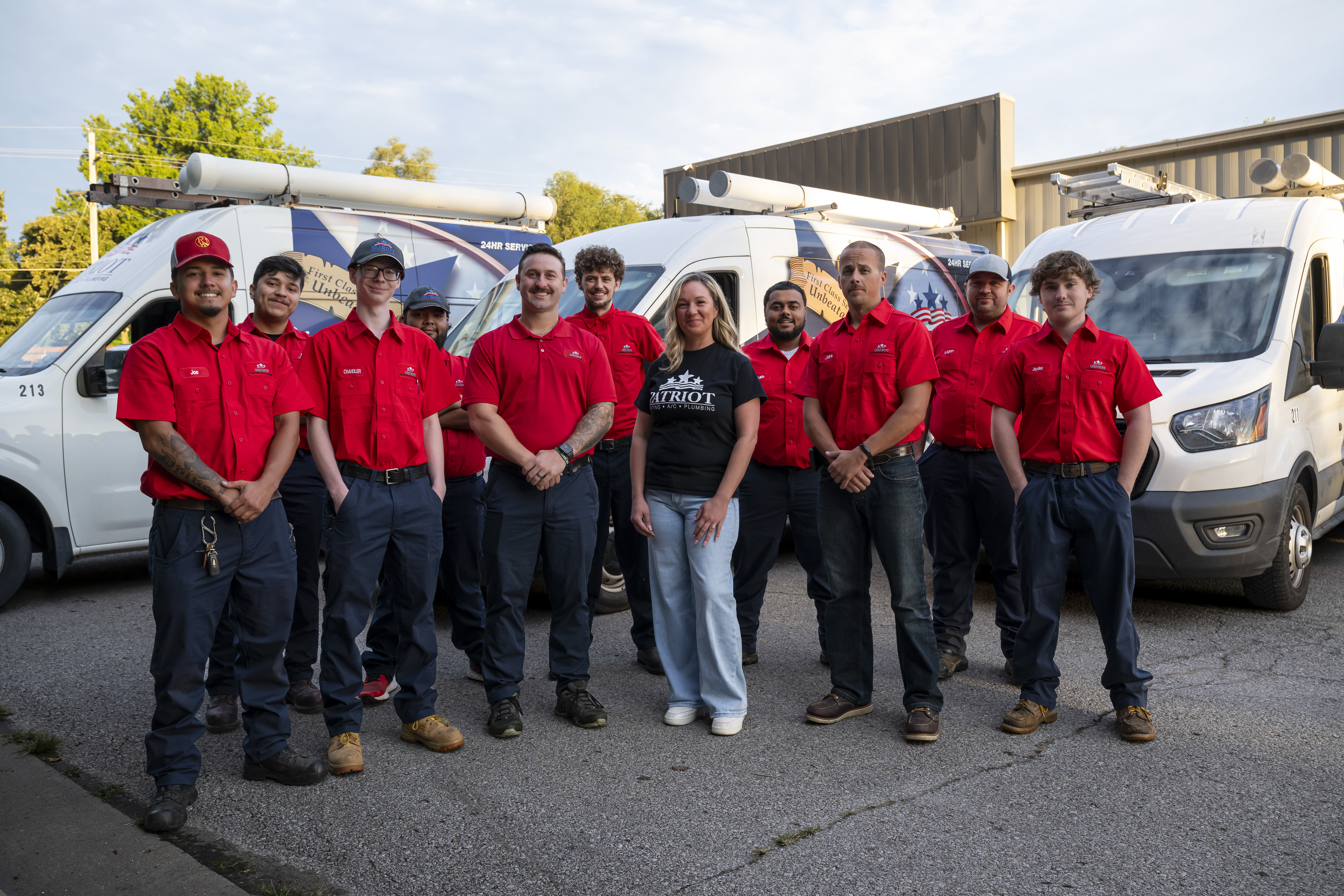 The Patriot Heating & AC team standing in front of their service vans