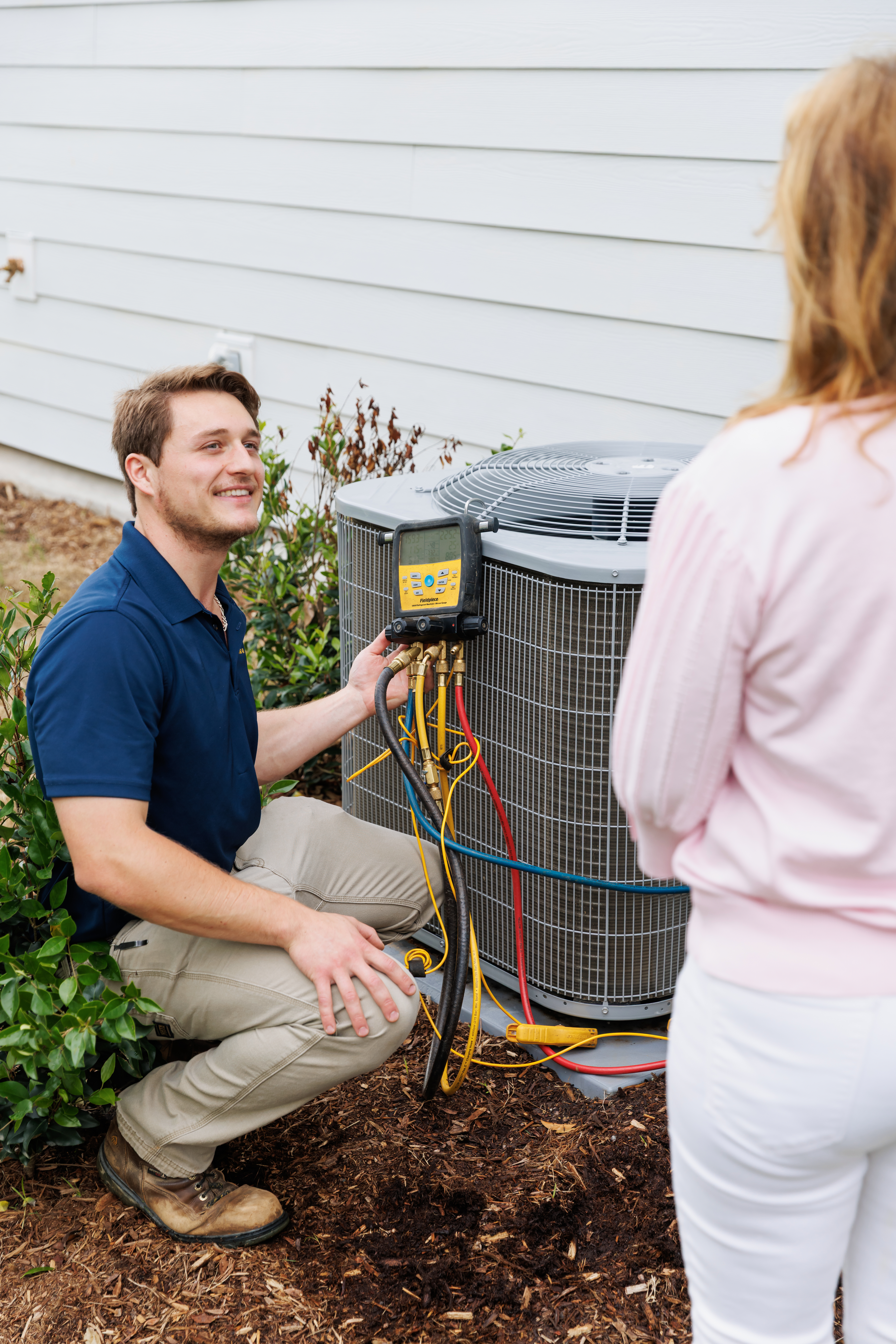 All American hvac technician maintaining AC