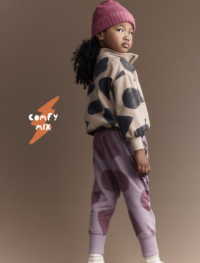 Toddler girl dressed in quarter zip pullover and city joggers printed with shape graphics