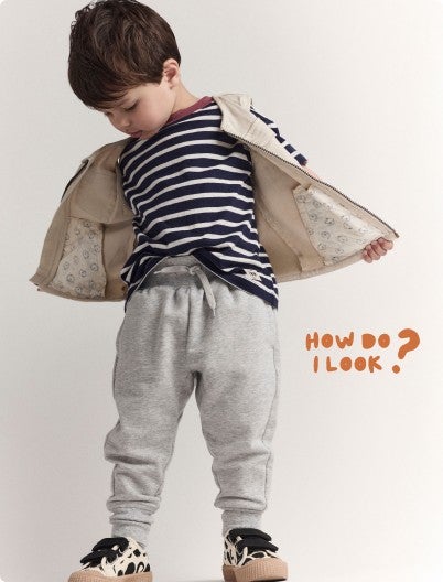 boy fanning out vest pockets to reveal otter print underneath