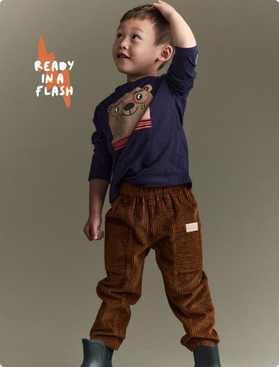 little boy dressed in otter graphic tee with corduroy pants