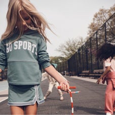 Girl with jump rope and "Go Sports" hoodie