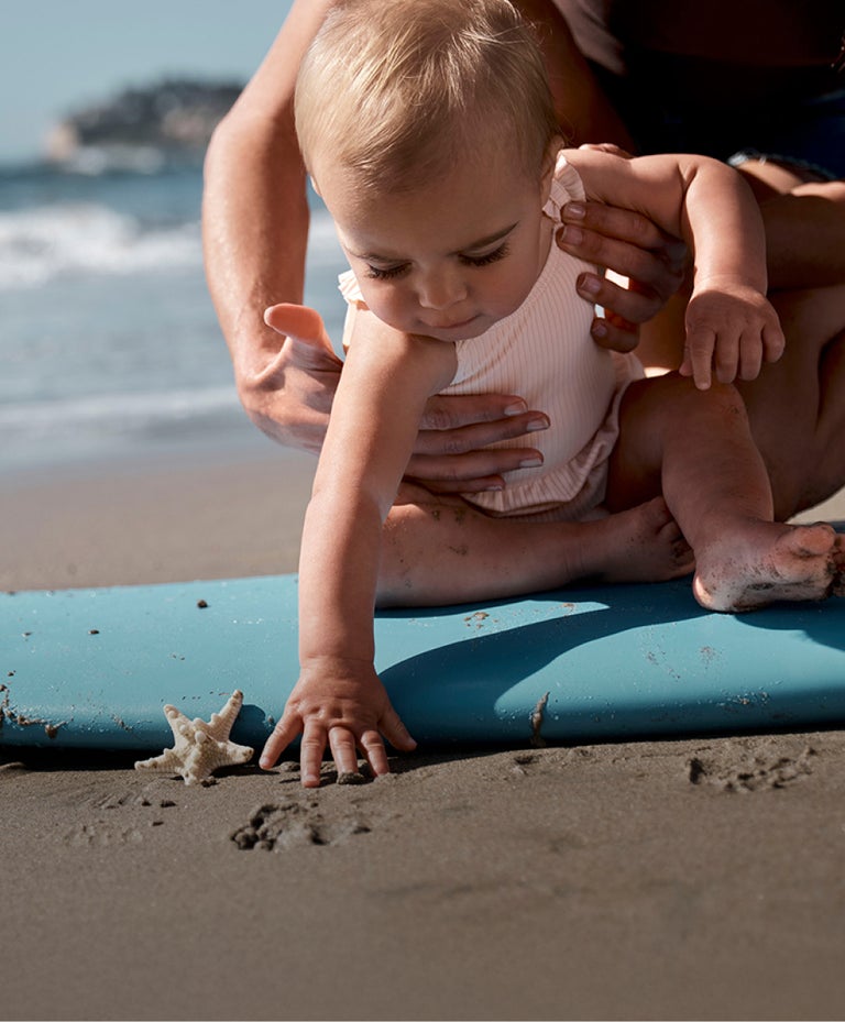 baby girl on a surfboard