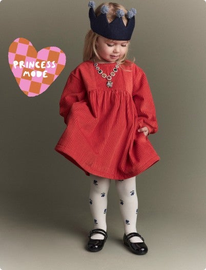 little girl with crown dressed in a corduroy dress and tights