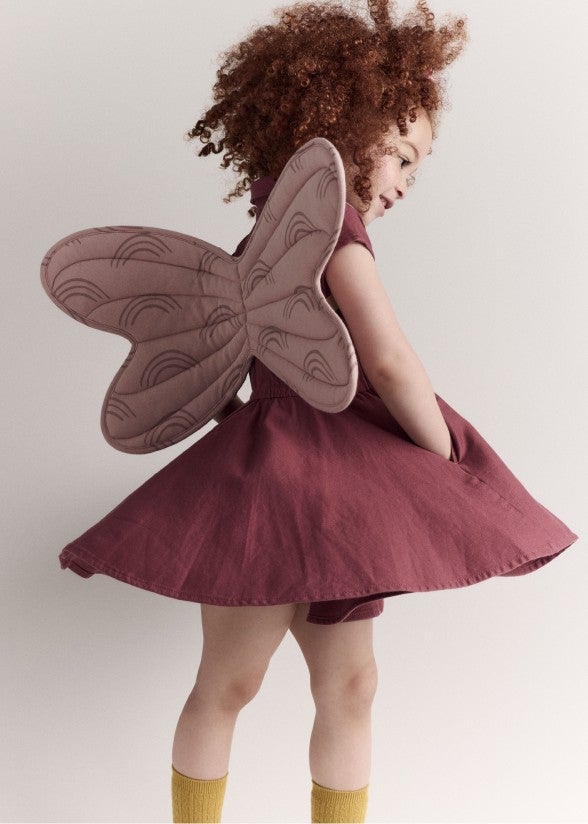 girl wearing a twirl dress and butterfly wings