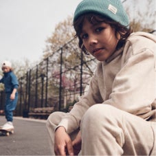 Boy sitting on basketball court