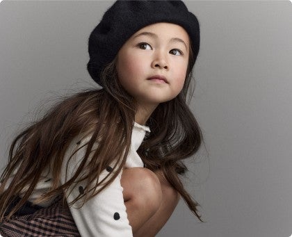 girl in beret and polkadot shirt