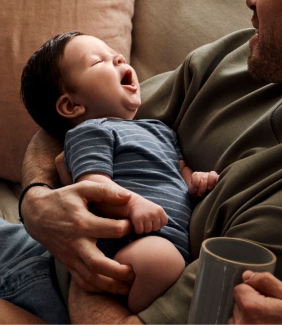 baby in arms, yawning