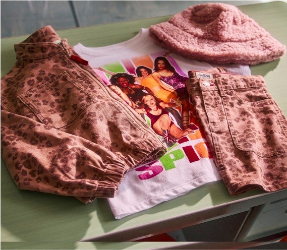 leopard print jacket and skirt laying on top of t-shirt