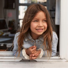 girl leaning out window