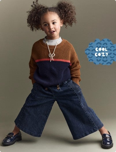 little girl dressed in cozy sweater and wide leg jeans