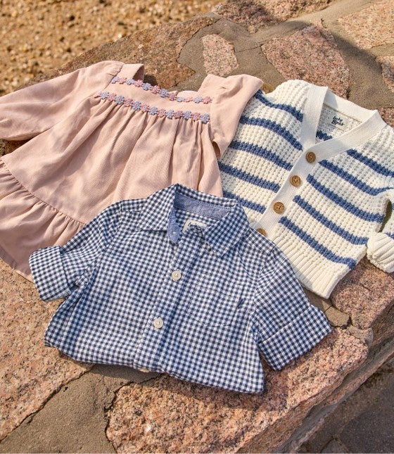 Baby B'Gosh tops laying on a rock