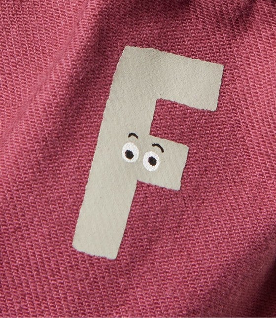 Graphic of "F" on fabric with eyes and eyebrows.