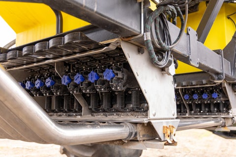 Closeup image of DrySet Air meters installed on a yellow air seeder.