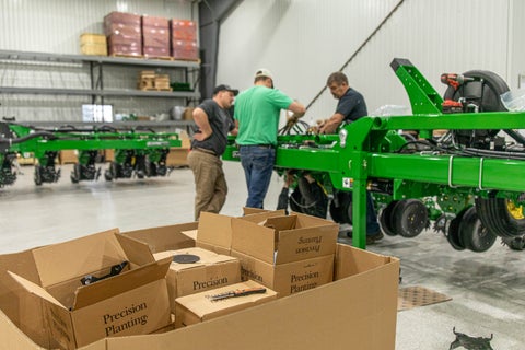 Precision Planting Dealers working on a planter build in a shop setting. 
