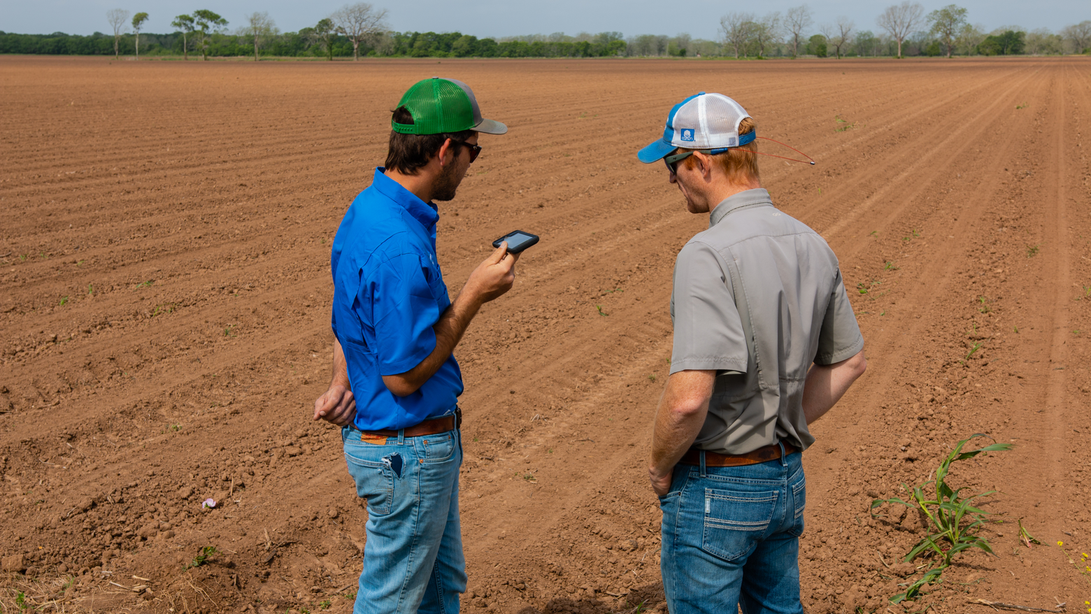 Precision Planting premier dealer talks to a farmer in a field