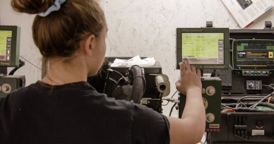 Premier Dealer employee calibrates a seed meter using a Precision Planting MeterMax stand.