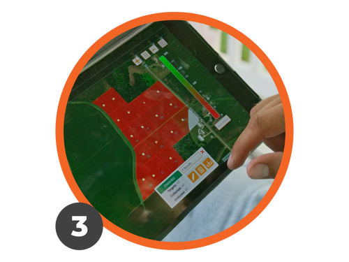 An agronomist taps the Radicle App screen on a tablet while sitting on a porch.