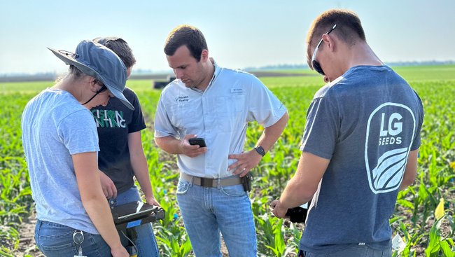 Precision Planting interns using POGO emergence tool in a field