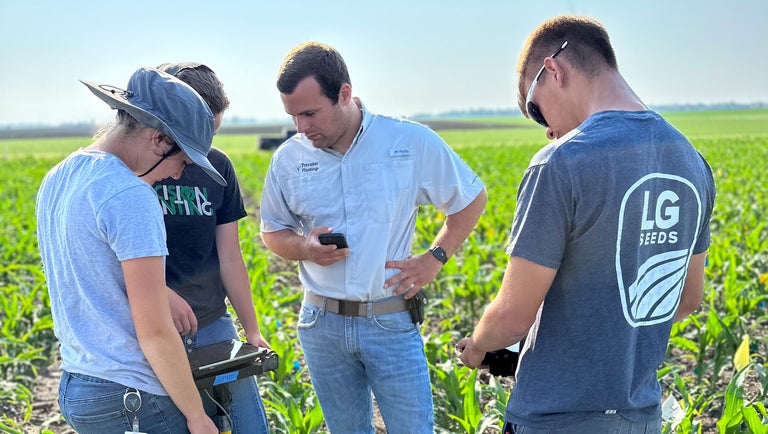 Interns scouting a field at Precision Planting
