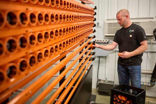 Man loading a GeoPress with a GeoTube