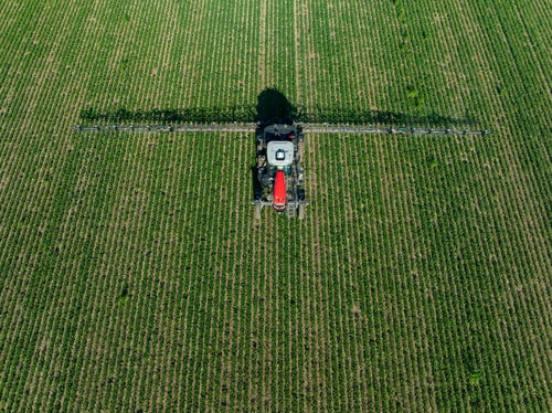 Overhead aerial image of Massy Ferguson self-propelled sprayer in-field spraying weeds with SymphonyVison | Spot.