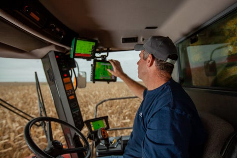 A farmer uses YieldSense from Precision Planting paired with a 20|20 to accurately track yield data