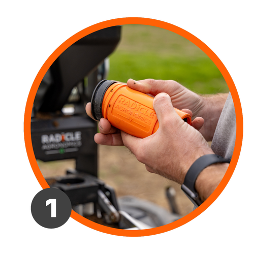 A farmer takes the lid off a GeoTube to place it in a GeoPress Lite.