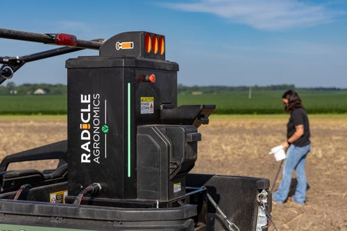 Farmer using GeoPress to collect soil samples in the field.